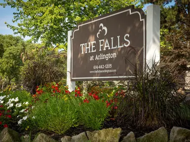 brown sign reading "The Falls at Arlington"