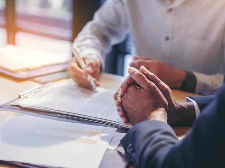 People reviewing and signing paperwork