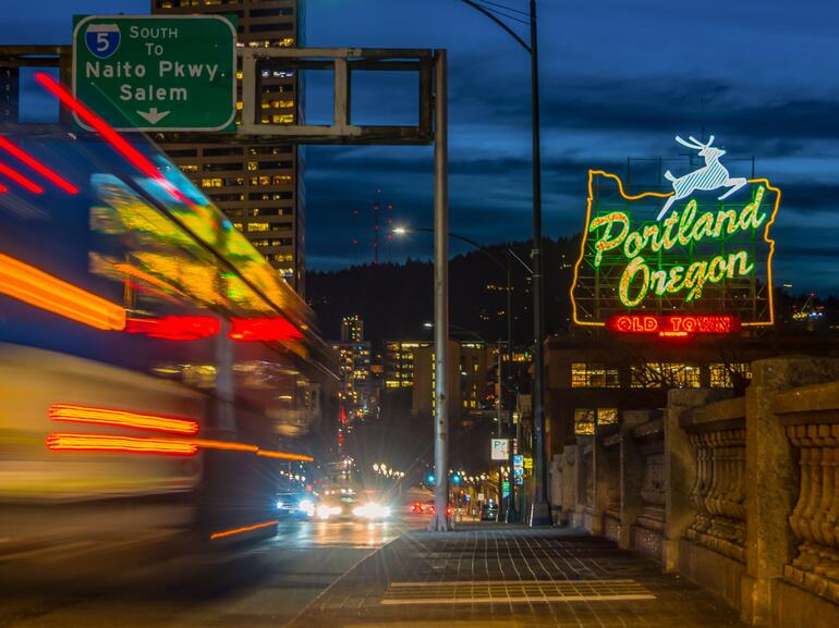 Skyline of Portland, Oregon at night with neon signs