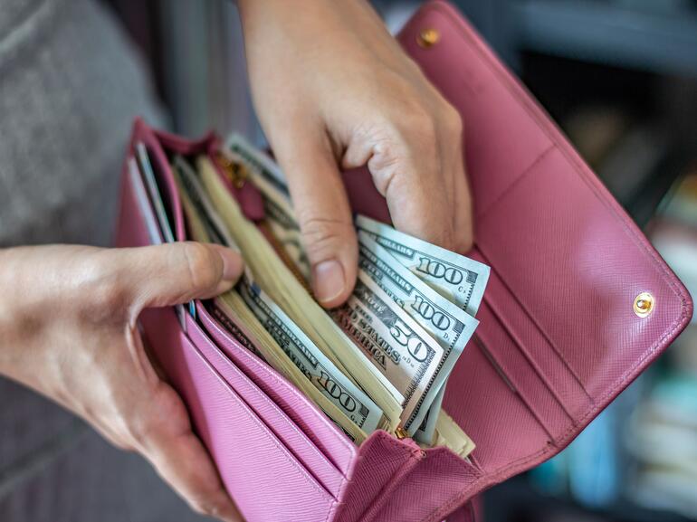 Person getting cash out a wallet