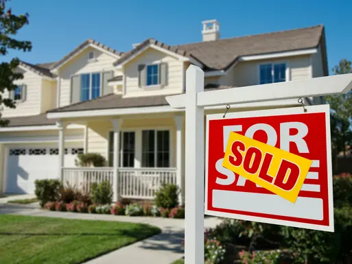 Single family, two-story home with sold sign out front