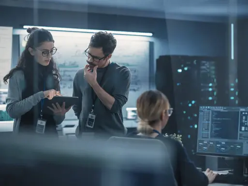 Portrait of Two Creative Young Female and Male Engineers Using Tablet Computer to Analyze and Discuss How to Proceed with the Artificial Intelligence Software