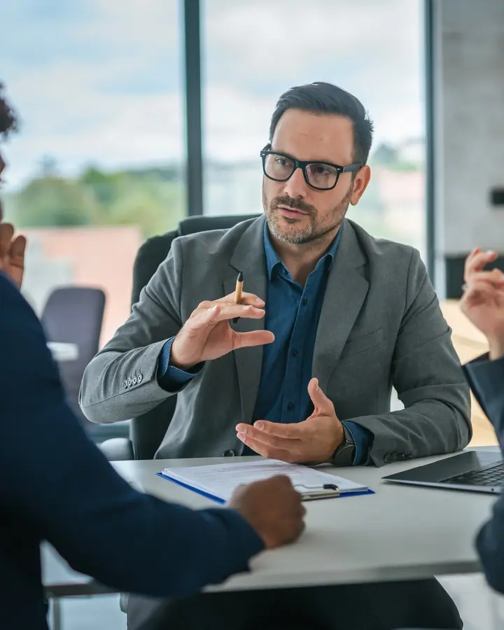 man at a desk discussing primary loan servicing